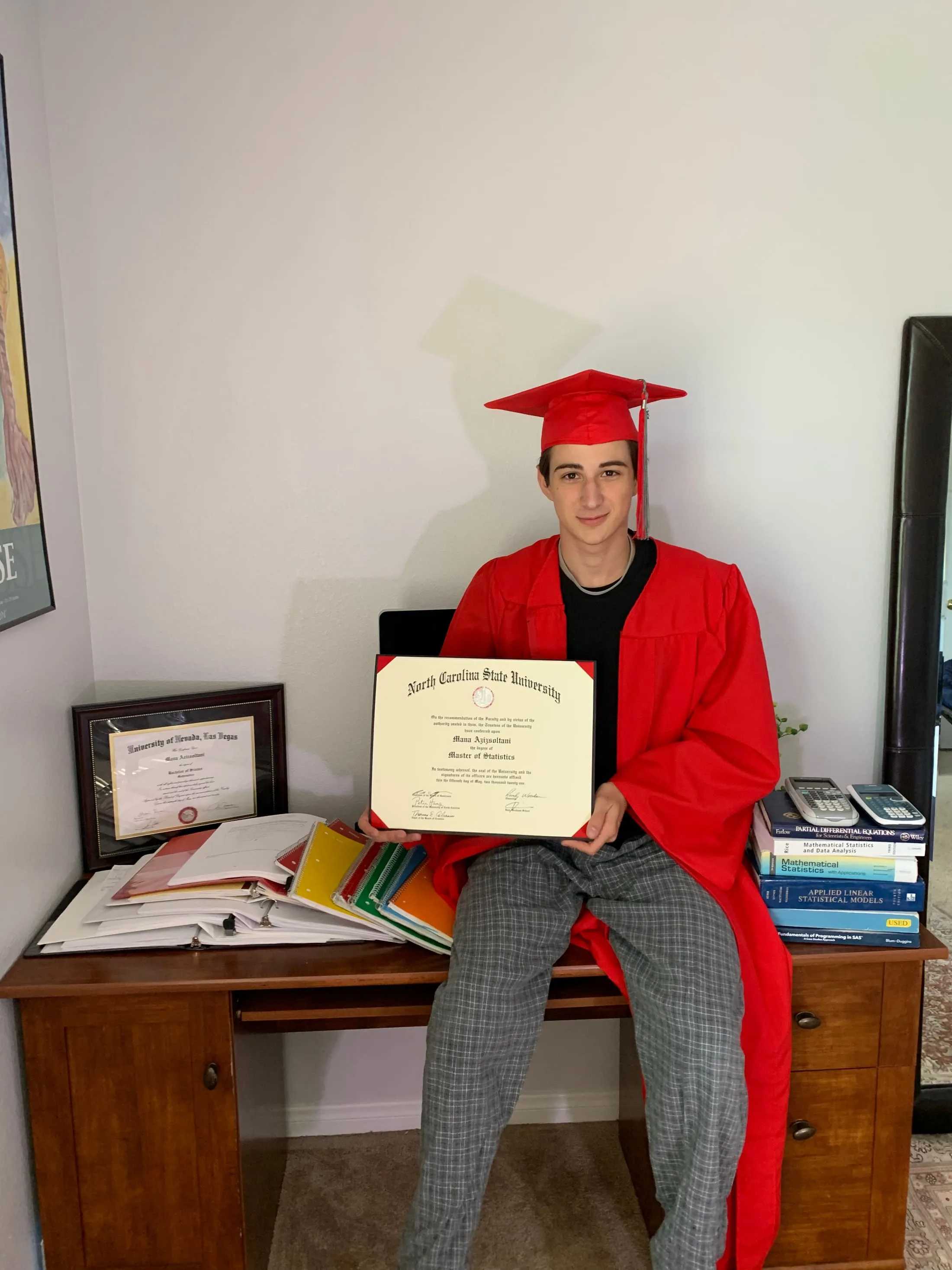 Mana Azizsoltani in graduation regalia holding a mathematics diploma