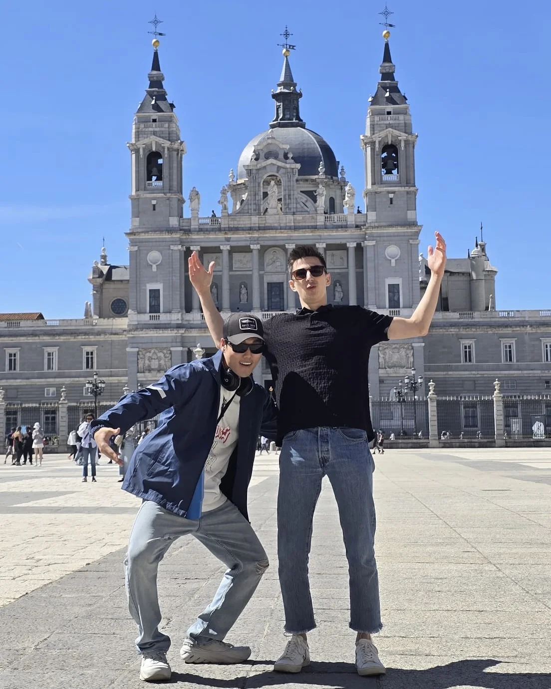 Mana Azizsoltani and Mark posing together in front of the Royal Palace of Madrid during the Spain trip