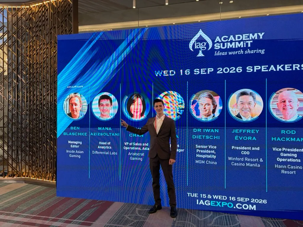 Mana Azizsoltani beside the IAG Academy Summit speaker board in Manila