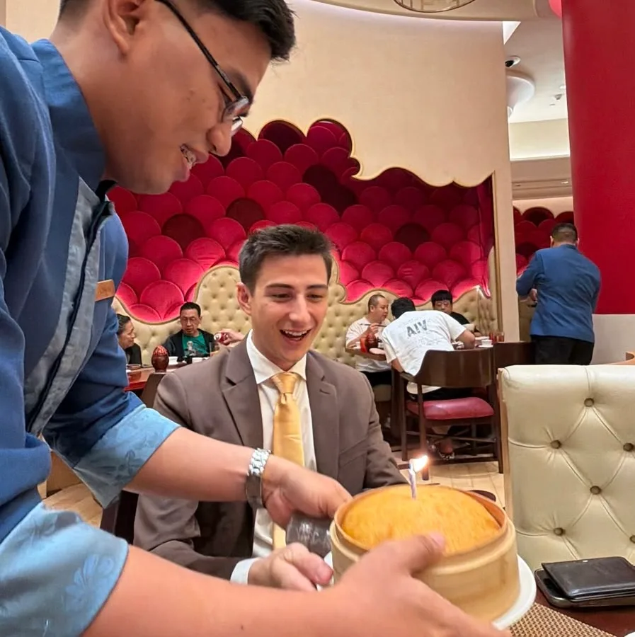 A birthday cake being served to Mana Azizsoltani in Manila