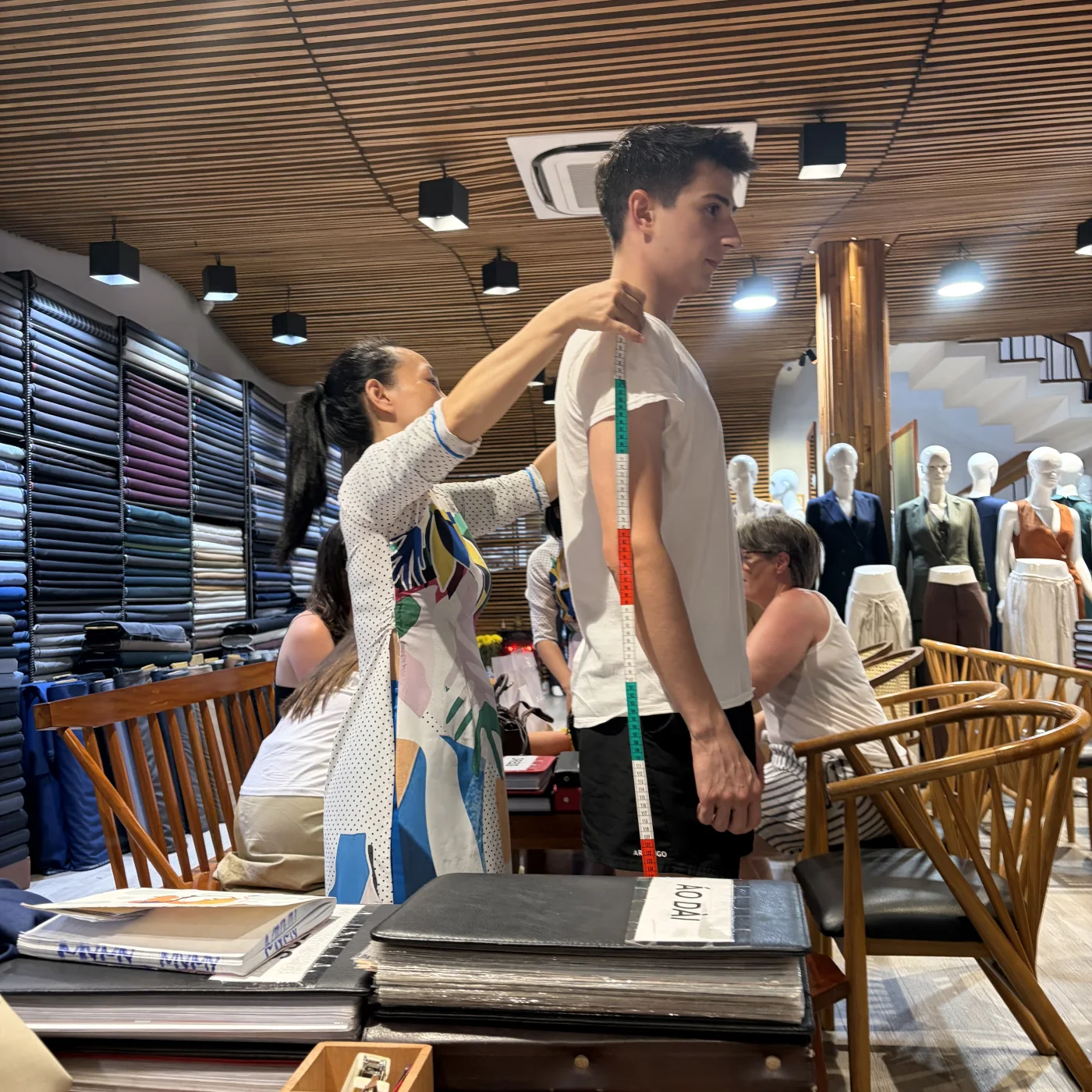 Mana Azizsoltani being measured for a bespoke suit by a tailor in Hoi An, Vietnam