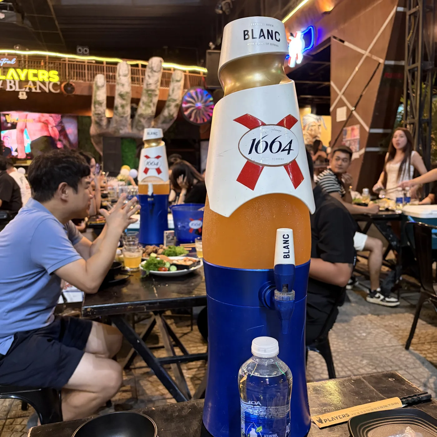 Oversized 1664 Blanc beer dispenser during a Monday night out in Da Nang, Vietnam